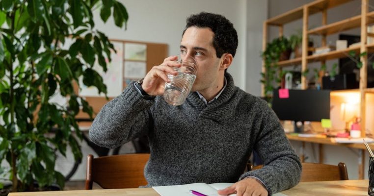 office worker drinking water at desk
