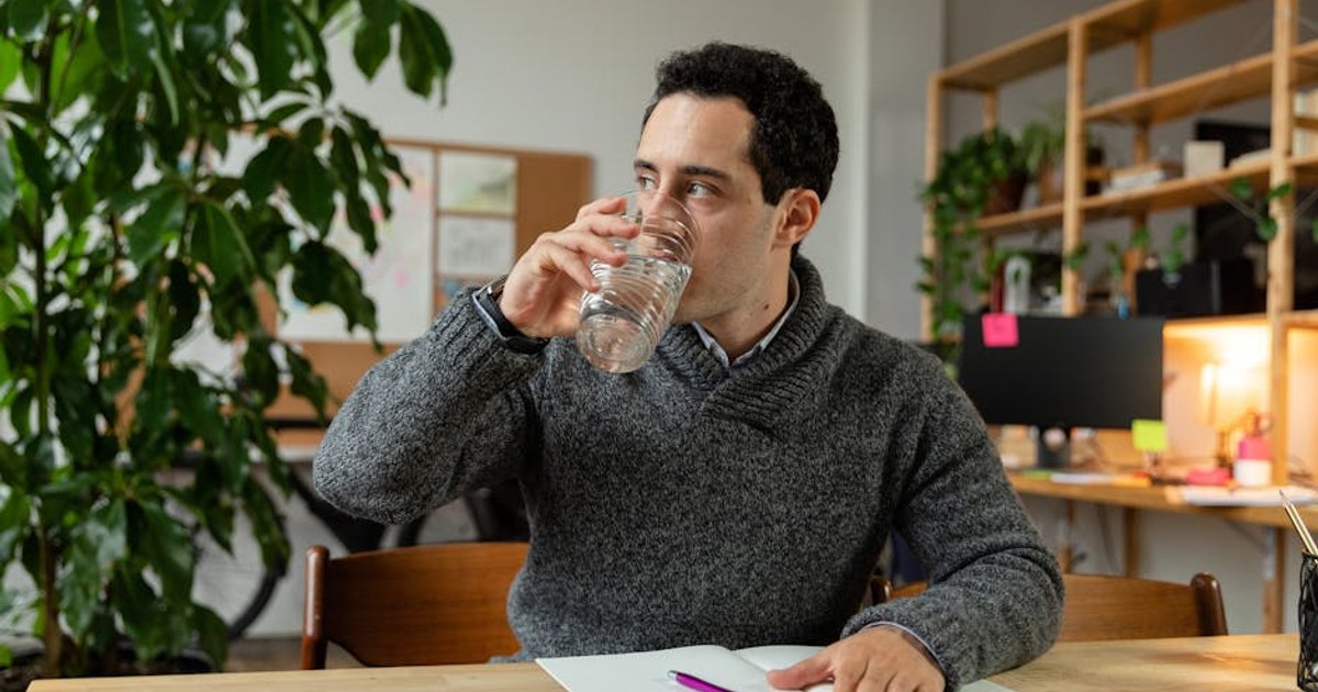office worker drinking water at desk